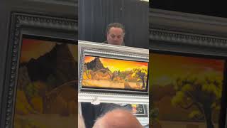 Michael Godard explaining one of his newest paintings