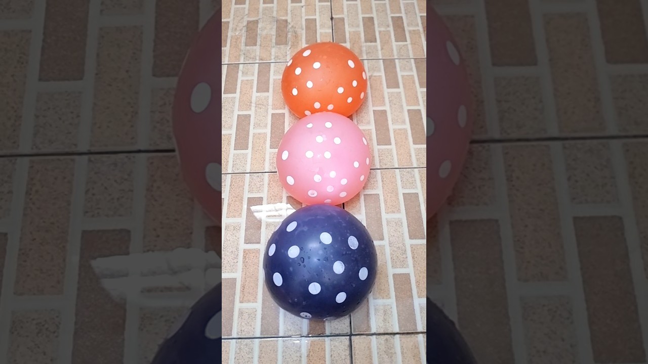 burst three orange, pink and purple polka dot balloons