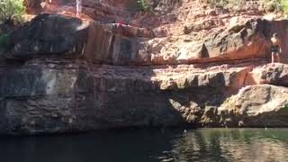 Girl attempts to cliff jump and lands on her rear at bottom of cliff