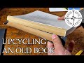 Upcycling an old book reclaiming materials  making a piercing cradle  making a pocket notebook