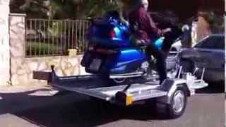 Trailer loading and unloading bikes quickly and safely with automatic anchoring wheel.Honda Goldwing