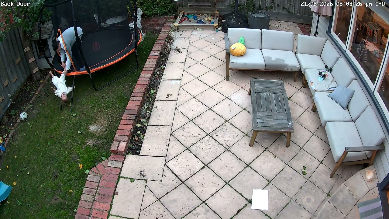 Girl falls through netting of trampoline and Dad saves her by grabbing her leg (Security camera)