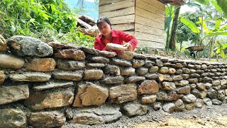 The girl used rocks and cement to build a wall to prevent landslides when it rained