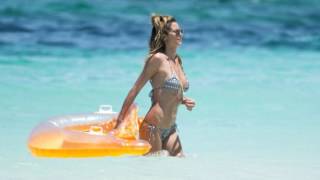 Heidi Klum in a patterned bikini on beach Turks and Caicos getaway