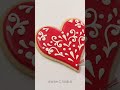 Decorating a Valentine’s Day cookie with royal icing