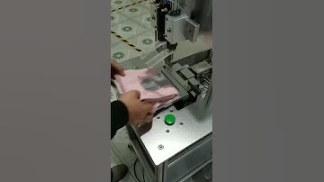 Automatic towel tag attaching machine