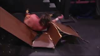 Joey Janela leg drops Kenny Omega through table
