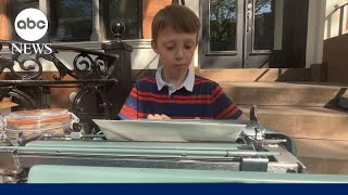 9yearold typist master is making Mother's Day cards with vintage typewriter