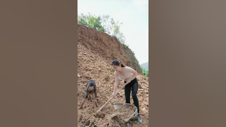 girl digging soil with dog
