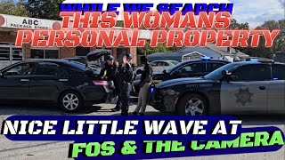 GCSO GIVES FOS THE CAMERA A WAVE WHILE THEY SEARCH A WOMANS PRIVATE PROPERTY