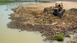 Awesome Heavy Old Bulldozer Working push soil and Heavy Dump truck unloading soil filling up.