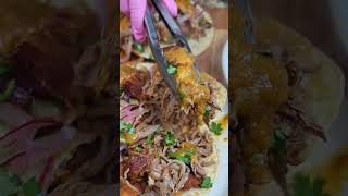 Loaded pulled pork tacos stacked with creamy avocado, smoky bacon, pickled onions, and rich homemade
