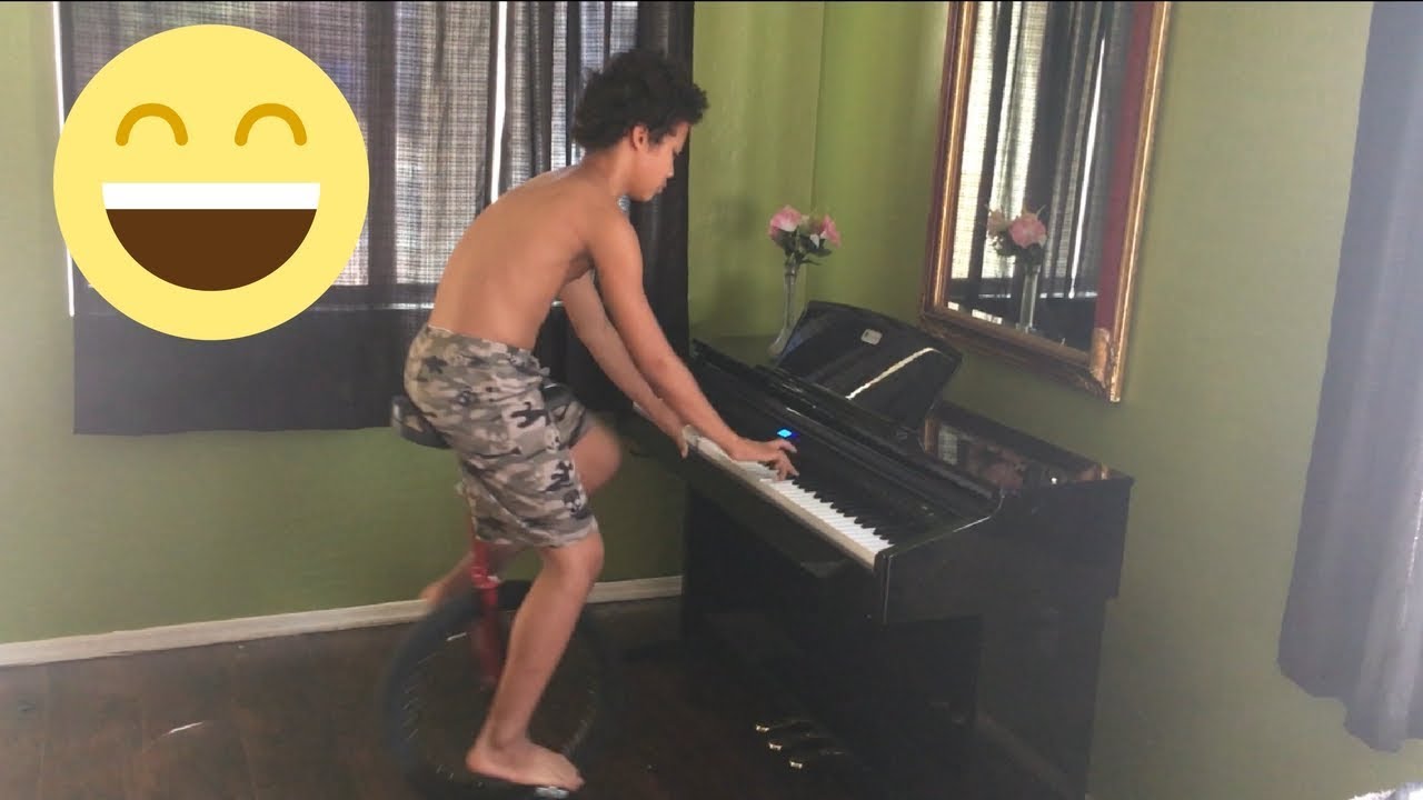 KID PLAYING PIANO ON UNICYCLE - YouTube