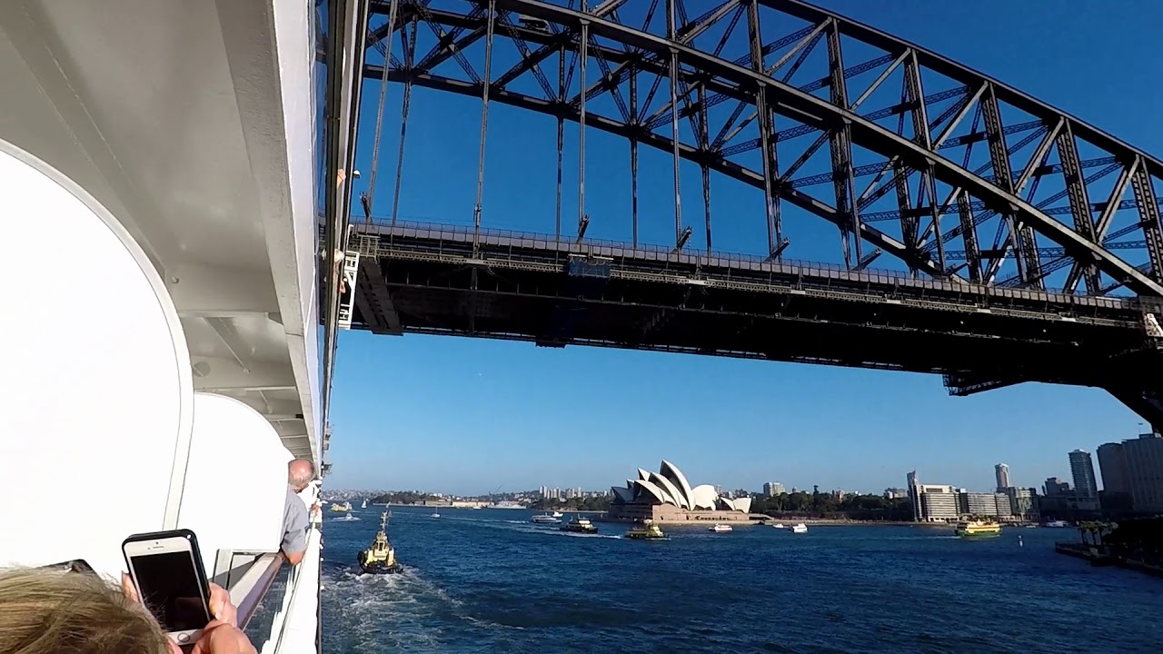 Cruise ship passing under Sydney Harbour bridge Australia