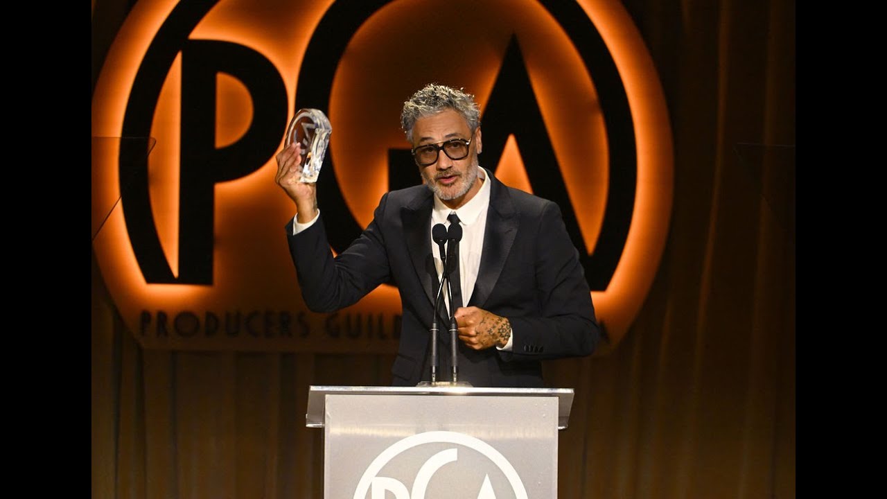 PGA Awards: Taika Waititi accepts the Norman Lear Achievement Award from Jon Favreau