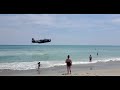 World War Two Plane Lands Close to Shore at Busy Beach During Florida Air Show