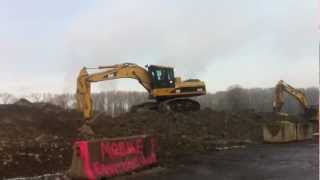 Caterpillar 330C FM Roadbuilder Excavator digging in demolition.