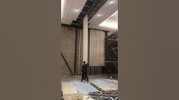 Installation site of movable partition project, testing the smoothness of door panel movement.