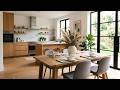 Modern Scandinavian Kitchen Dining Area With Wooden Table, Natural Light and Green Plants