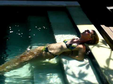 Dripping wet blonde girl farts in pool