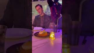 Waiter drops glass on guy dining