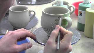 Ben Carter Decorating a mug with under glazes and sgraffito