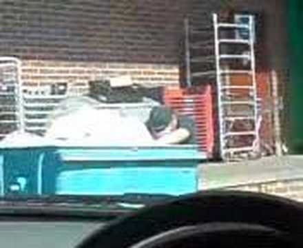 cheap removals man finds some food in a bin behind budgens and takes it back to his ldv.