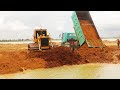 Extreme Bulldozer Pushing soil filling big lake Komatsu D60P with 10 wheel truck unloading soil