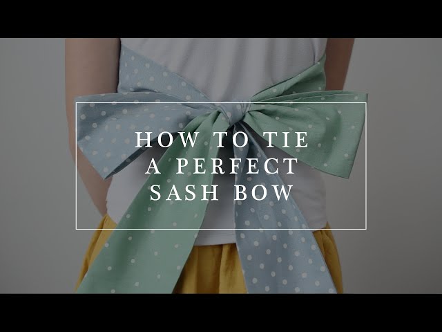 tying a bow on a dress