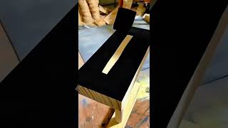 painting a wooden chair with black paint using a foam brush in a professional workshop carpentry
