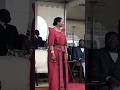 Queen of Buganda in maroon.