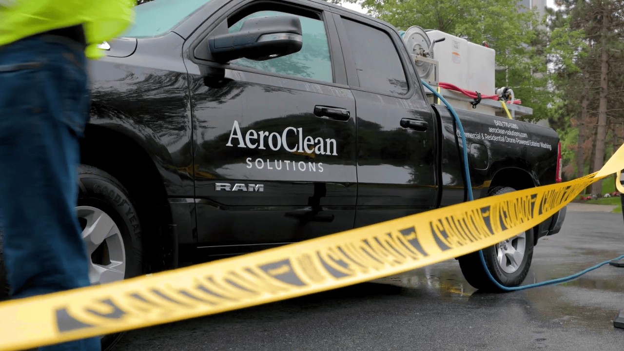 Aerial exterior cleaning on a commercial building for a property manager
