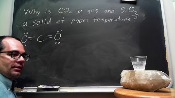 Why is CO2 a gas and SiO2 a solid at room temperature?
