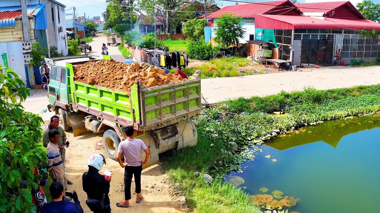 incredible whole complete full project ! truck transport soil , bulldozer push soil stone to water
