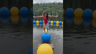 High-level focus on her balance and movement across the water obstacles.