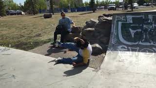 Skateboarder rides up half pipe and hits head on a rock on the way down at the skatepark