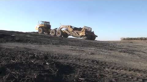 Volvo A40E ADT Pulling Loaded K-Tec 1233ADT Scraper Uphill and Unloading.
