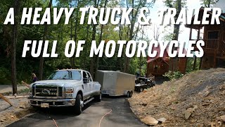 A Heavy Truck & Trailer Full Of Bikes On A Steep Incline