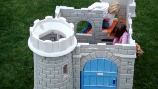 Kids playing with little tykes castle, with a guard dog!