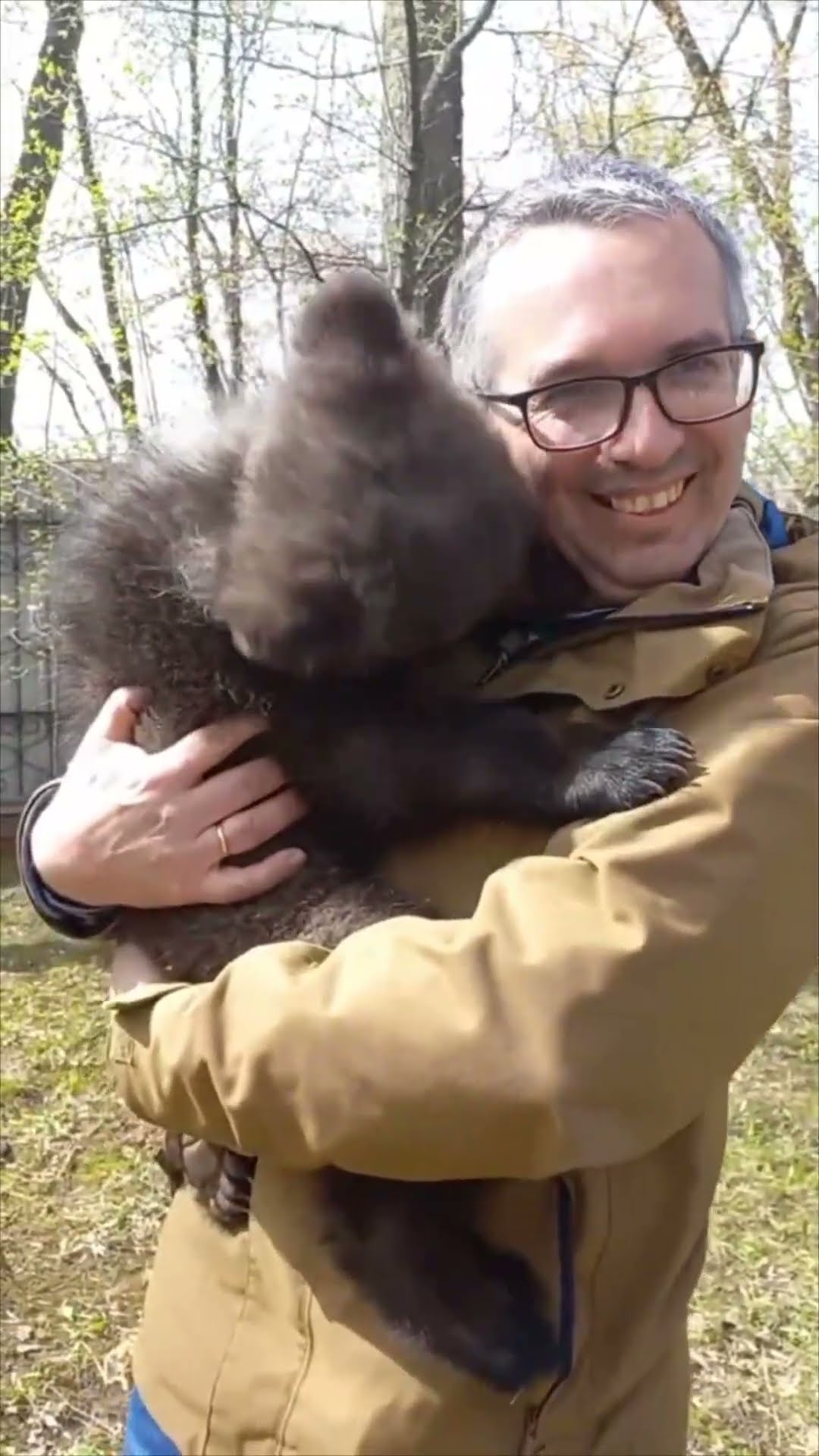 Bear Cub Gives a Sweet Hug to Its Caretaker