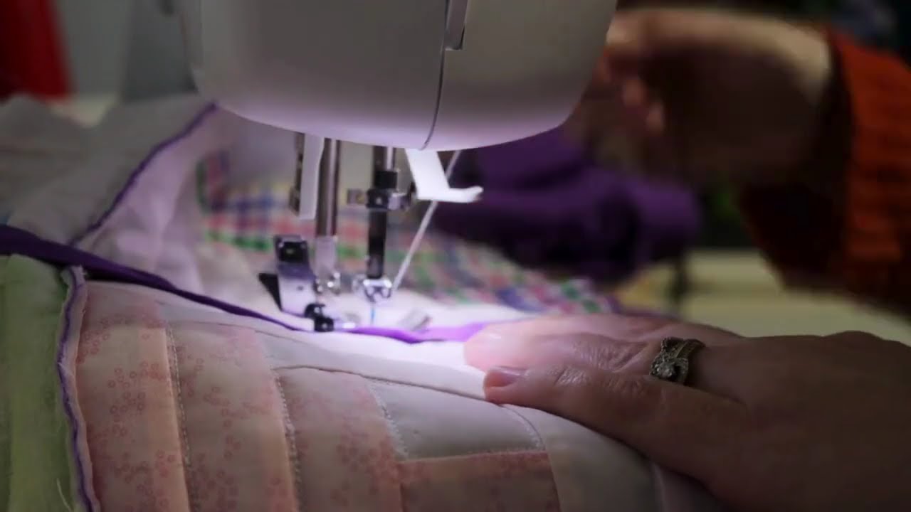 Baby Quilt - Sewing the cover strips over the top seams