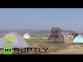 Greece: Farmer PLOUGHS land where refugees are living in tents