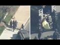 Naked man accused of breaking car windows taken into custody after standoff
