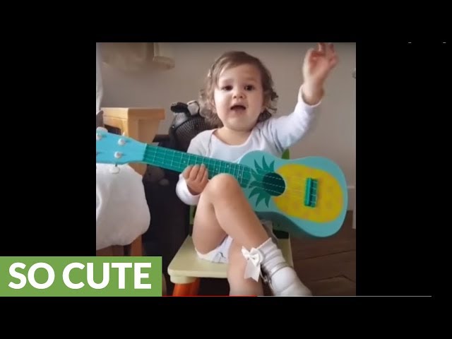 Adorable baby girl hilariously plays the guitar