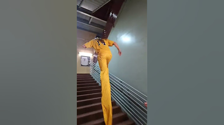 Performer is walking through the ballpark on stilts!