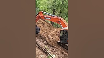 Unearthing Progress: Excavator Unleashes Power in Mountain Village for Road Construction