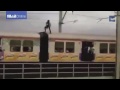 Daredevil man in india stands dangerously on fast moving train
