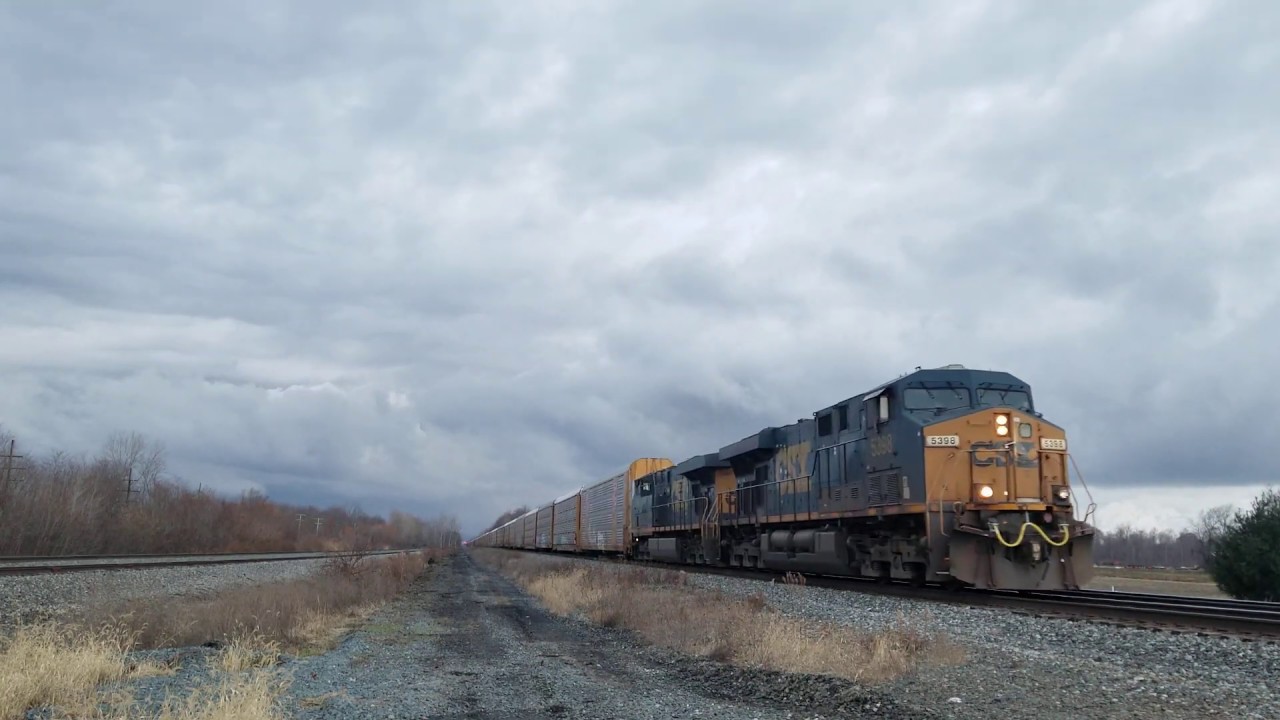 CSX autorack train with boxcars meeting an intermodal train - YouTube