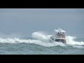 Boats leaving rough inlet