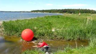 Wet Clothes By Attemp To Sit On A Gymnastic Ball, Postioned In A Ditch